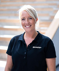 a blond-haired lady in a black t-shirt
