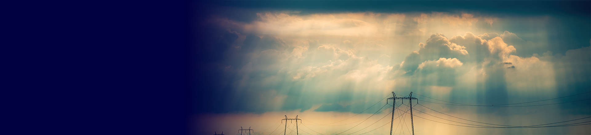 Electricity pylons under a biblical sky