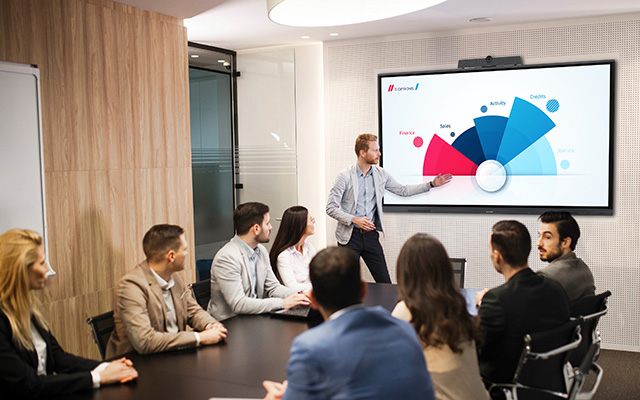 People sat around a meeting room table