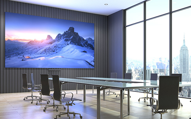 A board room with table and large LED screen